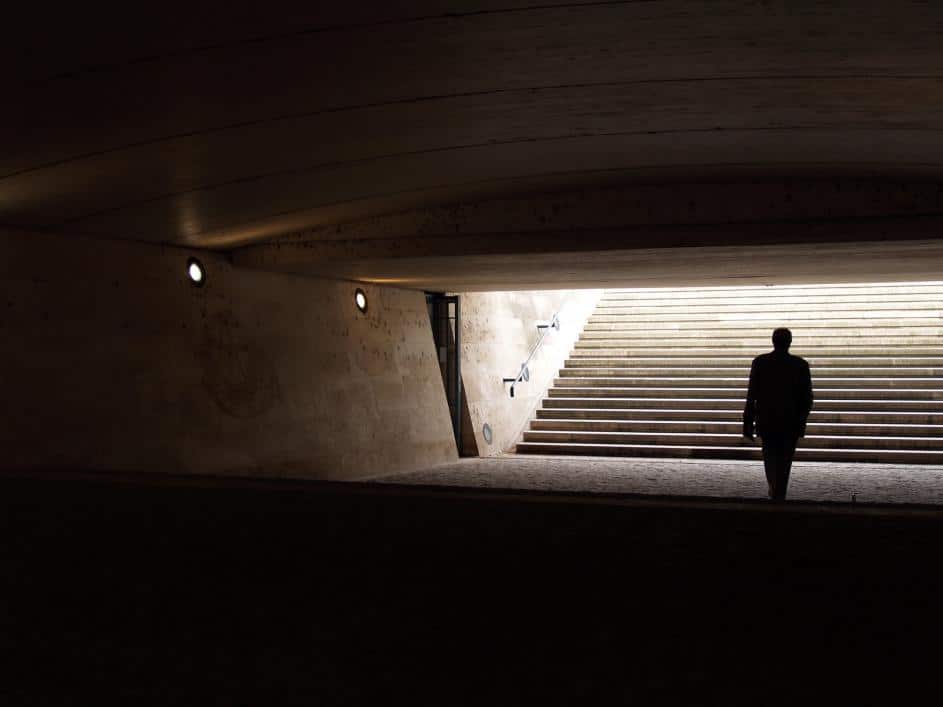 man wandering in dark Subway system