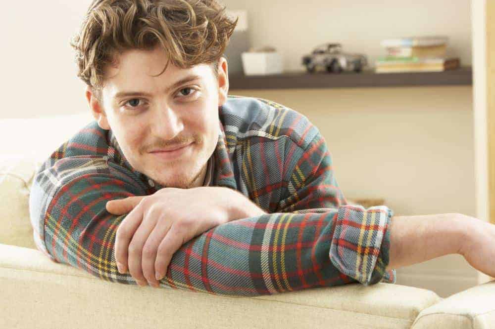 image of a man on the couch looking relaxed.