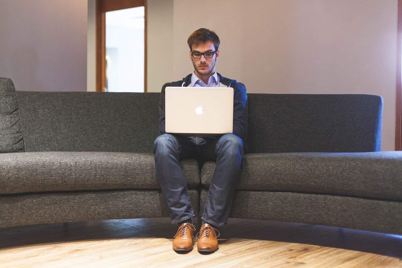 man on couch working