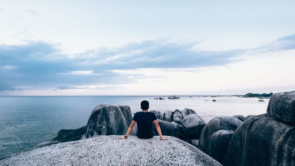 man staring at ocean