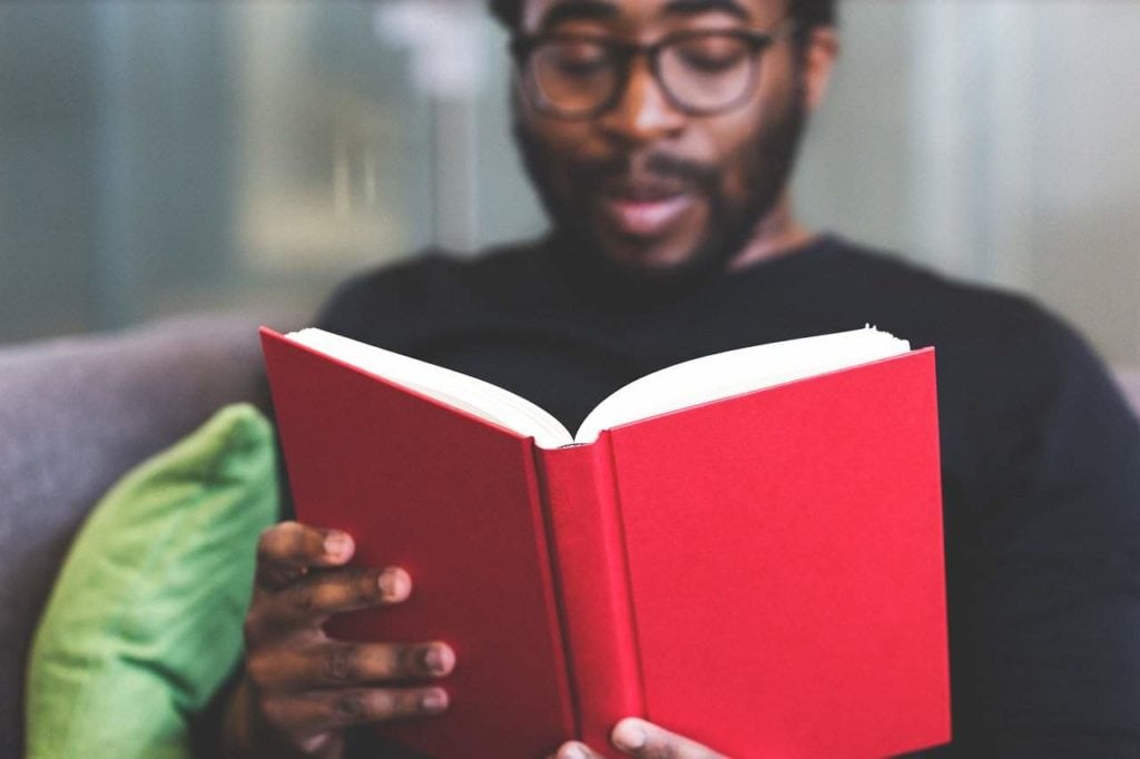 man reading literature