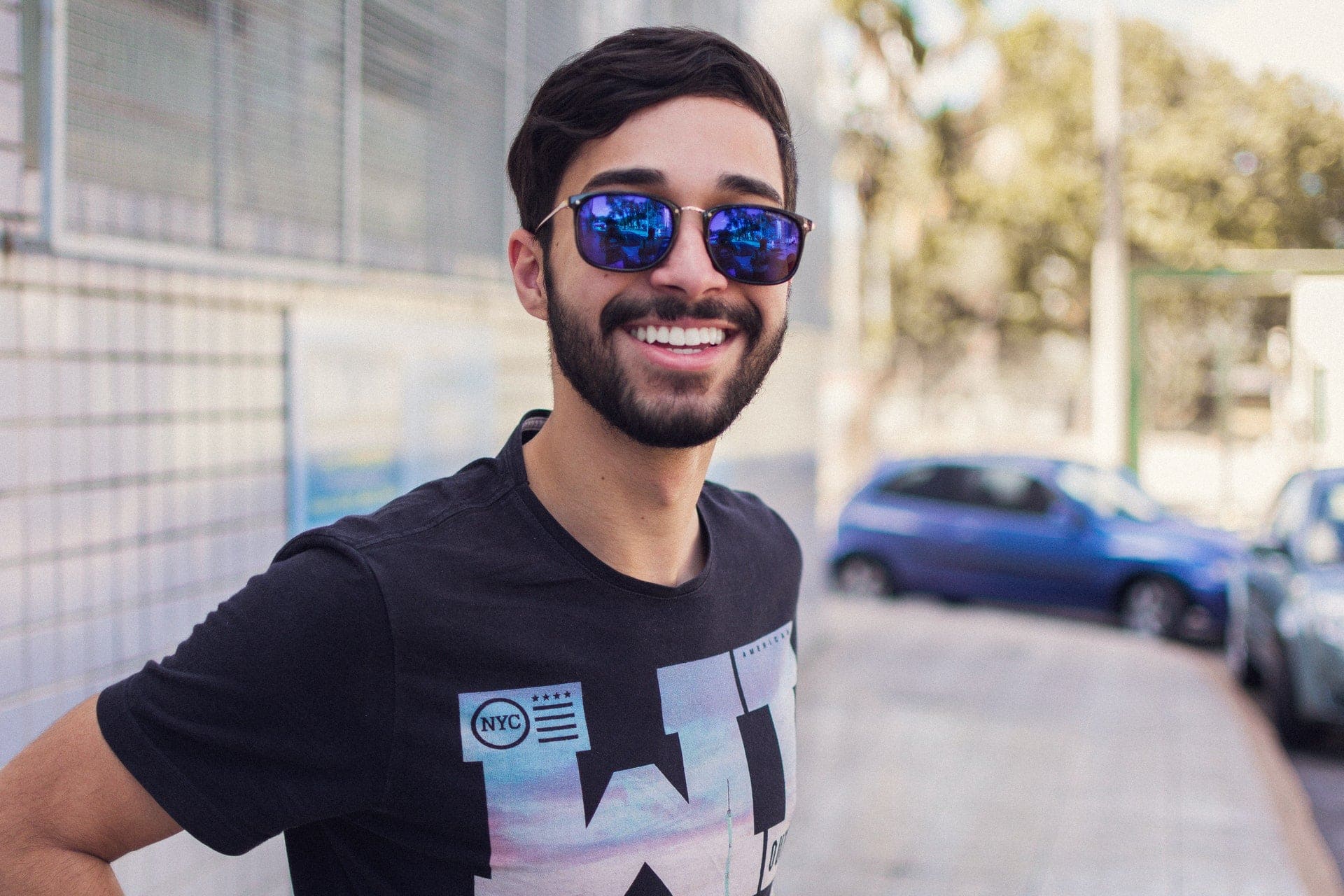 man smiling in big sunglasses