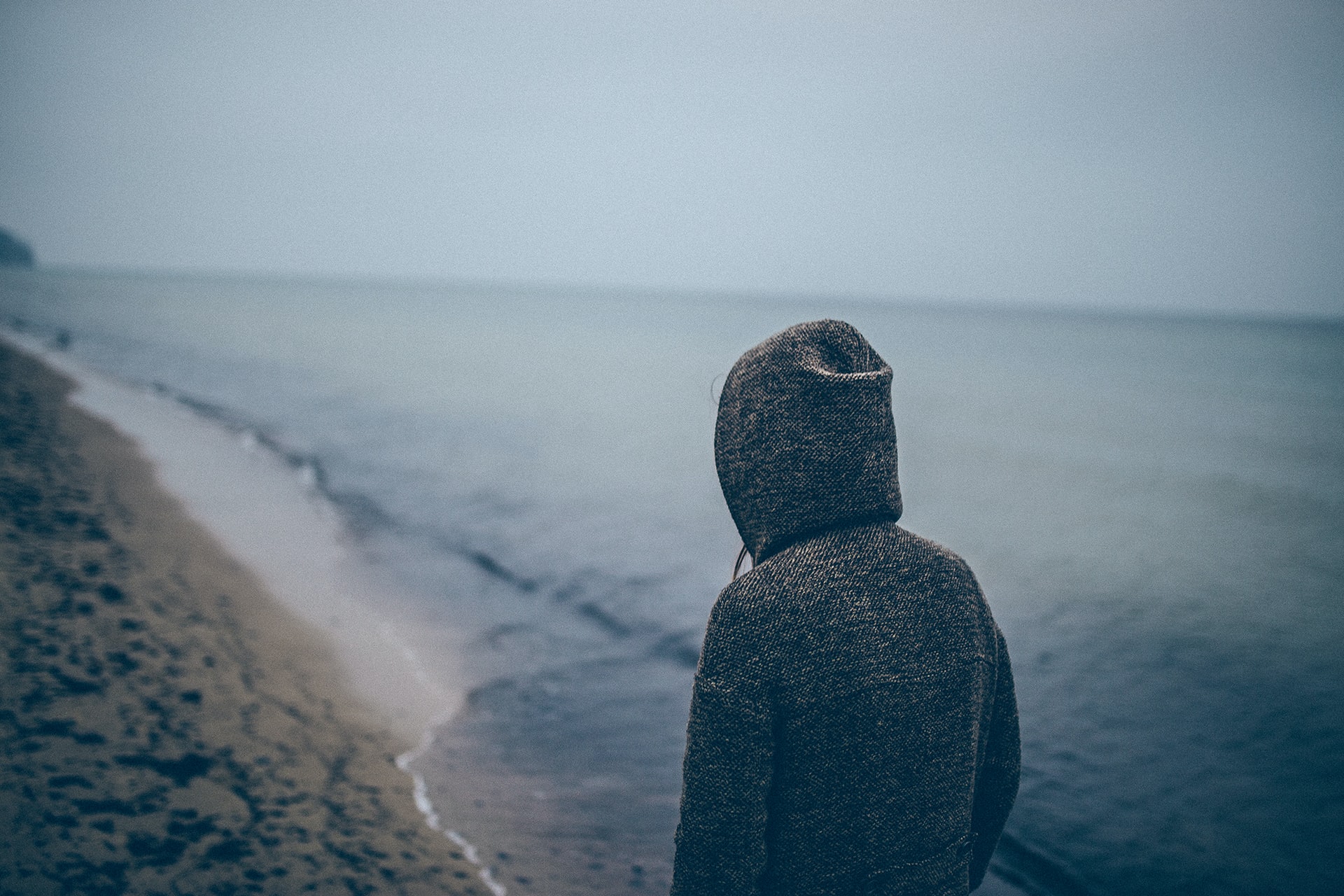 man on beach on ugly day