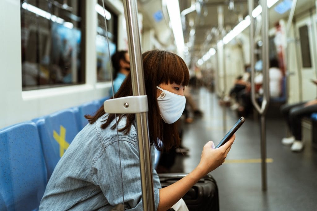 woman reading while on subway being patient