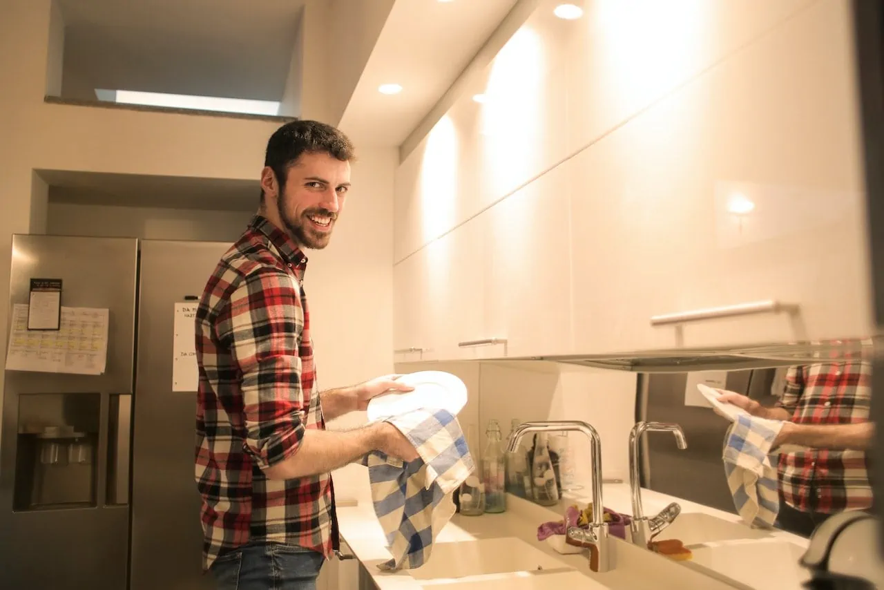 man in sober living learning responsibility with chores