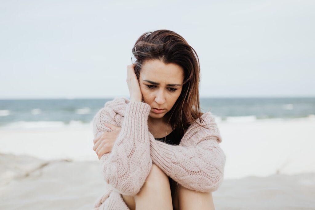 sad woman thinking about tranq dope on beach